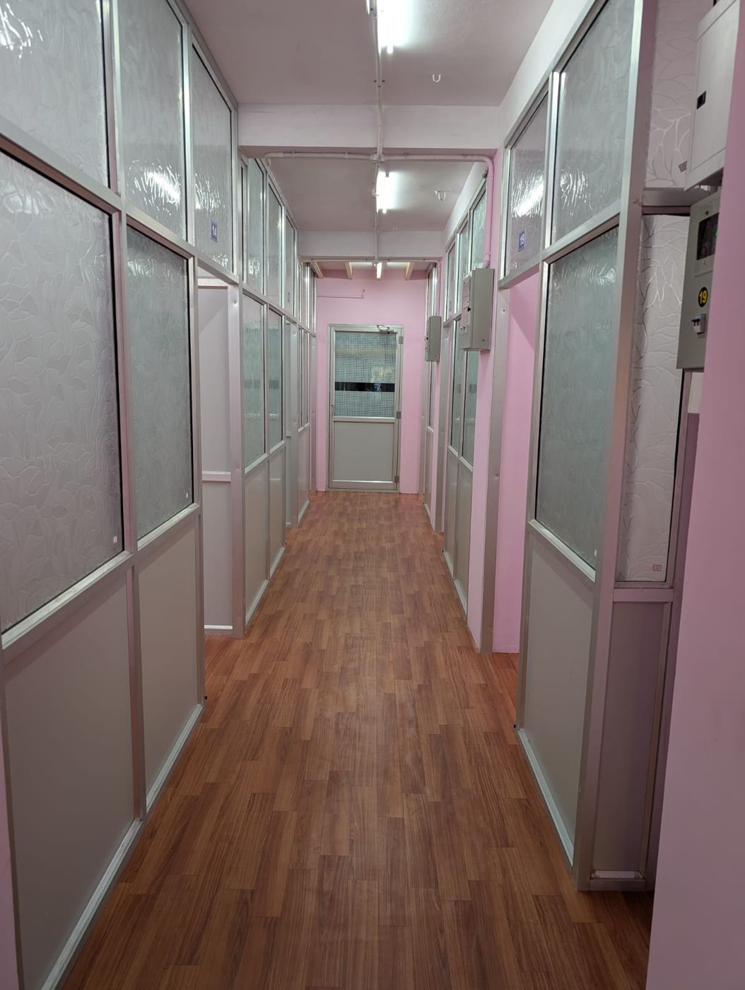 Corridor lined with partitioned office rooms